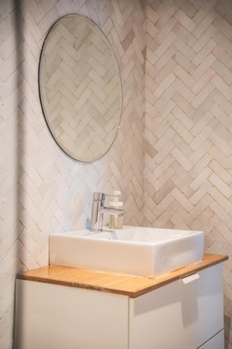 a bathroom with a white sink and a mirror at Villa Le Belvedere in Tangier