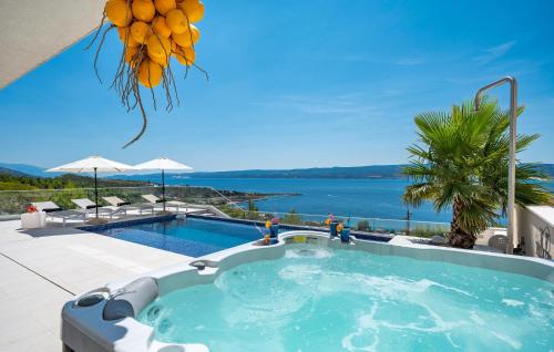 a swimming pool with a view of the water at 3 Bedroom Lovely Home In Dugi Rat in Dugi Rat