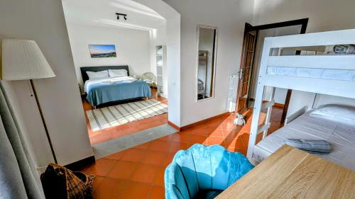 a bedroom with a bunk bed and a room with a bed at Villa Perla, hilltop location with pool in Calosso