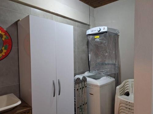 a small bathroom with a sink and a washing machine at Casa BuLuMAR in Conventos