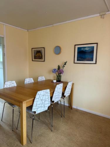 a dining room with a wooden table and chairs at STF Malmfältens Folkhögskola in Kiruna
