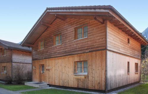 a wooden house with a gambrel roof at Tolles Feriehaus Montafon in Bartholomäberg