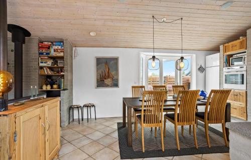 a kitchen and dining room with a table and chairs at Cozy Home In Otterup With Wifi in Otterup