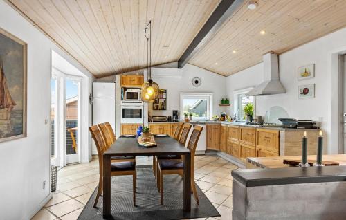 a kitchen with a table and chairs in a room at Cozy Home In Otterup With Wifi in Otterup