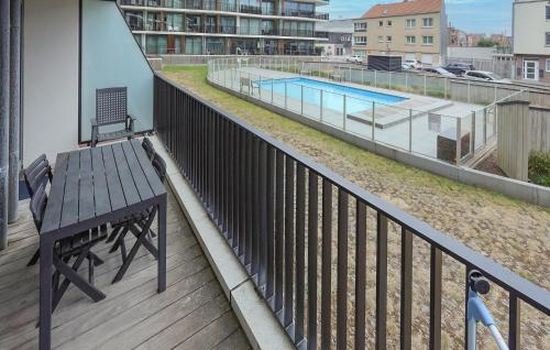 a wooden balcony with a bench and a swimming pool at Residentie Crystal Ref 99 in Ostend
