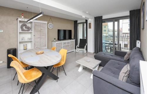 a living room with a couch and a table at Residentie Crystal Ref 99 in Ostend