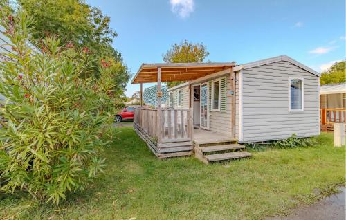 a tiny house with a porch and a deck at Stunning Stacaravan in Saint-Georges-de-Didonne
