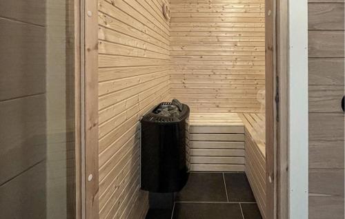 a corner of a sauna with a trash can at Cozy Home In Dörarp With Sauna in Dörarp
