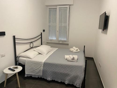 a small bedroom with a bed and a tv at B&B Ladislaus in Ladispoli
