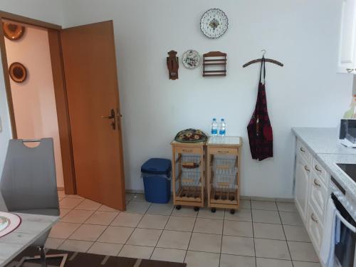 a kitchen with a door and a table and a counter at Oase im Grünen Pad1 in Neuenhagen