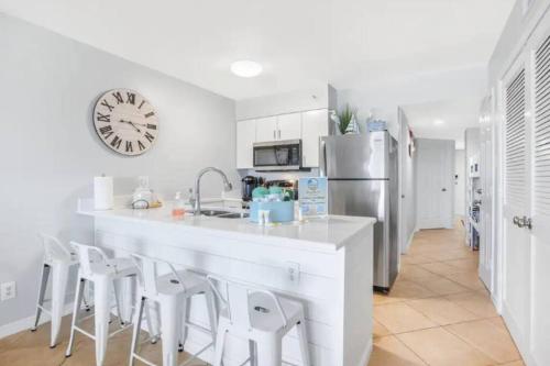 a kitchen with a large counter and a refrigerator at Breezy Does It Royal Palms 404 DIRECT GULF FRONT in Gulf Shores