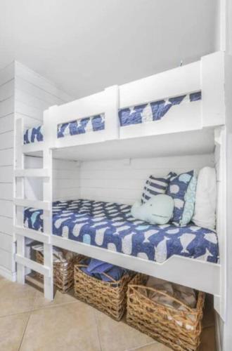 a white shelf with blue and white towels and baskets at Breezy Does It Royal Palms 404 DIRECT GULF FRONT in Gulf Shores