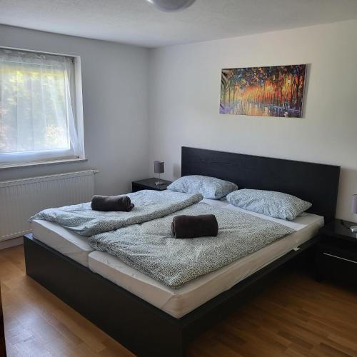 a bedroom with a bed with two pillows on it at Bel - Self Check-Inn in Eggenfelden