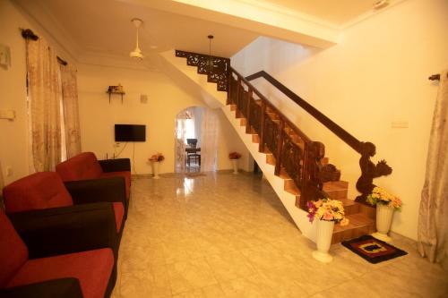 a living room with a staircase in a house at ASNA Homestay in Dambulla