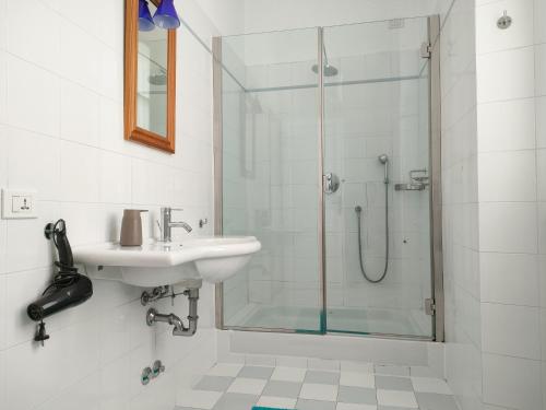 a bathroom with a sink and a shower at Villa Scalabrini in Como
