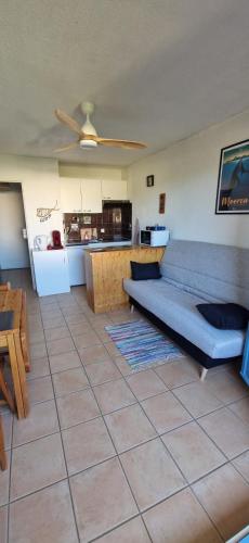 un salon avec un canapé et une cuisine dans l'établissement Quiet T2 with pool near beach and port, à La Londe-les-Maures