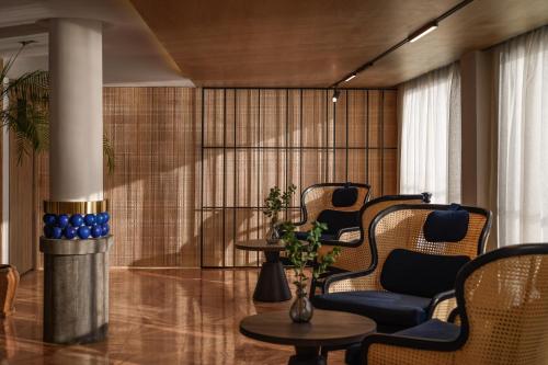 a lobby with chairs and a table and a column at Soleil Nile Cruise - Every Monday from Luxor for 4 & 7 Nights, and every Friday from Aswan for 3 & 7 Nights in Luxor