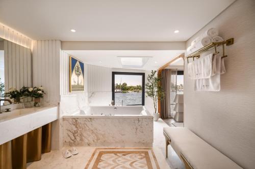 a bathroom with a tub and a sink at Soleil Nile Cruise - Every Monday from Luxor for 4 & 7 Nights, and every Friday from Aswan for 3 & 7 Nights in Luxor