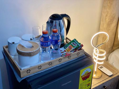 a drawer with drinks and other items on a table at BryMac Hotel in Koforidua