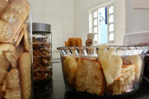 a counter top with jars of bread and pastries at Aloha Pousada Cabo Frio Hospedagem Econômica in Cabo Frio