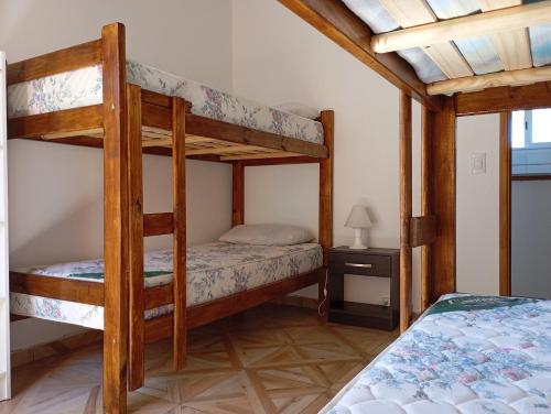 a bedroom with two bunk beds in a house at Los Poin 2 in Mar de Cobo