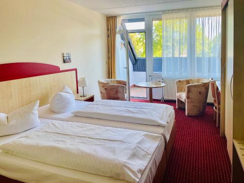 Postel nebo postele na pokoji v ubytování Morada Hotel Am Mellensee