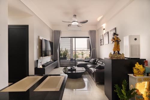 a living room with a couch and a ceiling fan at CENTANA Thu Thiem - Serviced Apartment - Saigon - District 2 - Q2 - Ho Chi Minh City - Netflix, FPT TV, Youtube Premium, Playstation 5, Workstation - Super WiFi in Ho Chi Minh City