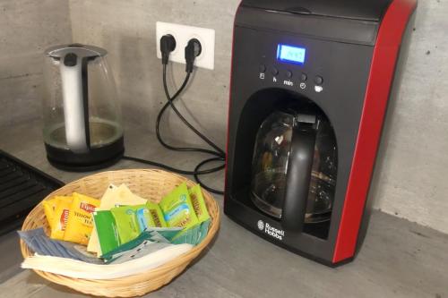 a basket of food next to a toaster oven at Bienvenue dans notre gîte "Le Chti Père" pouvant accueillir 6 personnes à Artonne, dans les Combrailles Puy de Dôme, 63 in Artonne