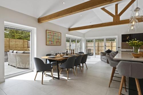 a dining room with a table and chairs at The Old School House - A Superb Newly Converted Barn with Hot Tub Sleeping 8 guests in Carmarthen