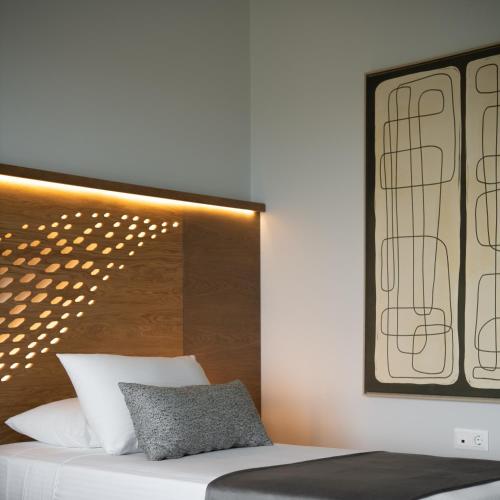 a bedroom with a bed with a light above it at Villa Kalliston in Rethymno Town