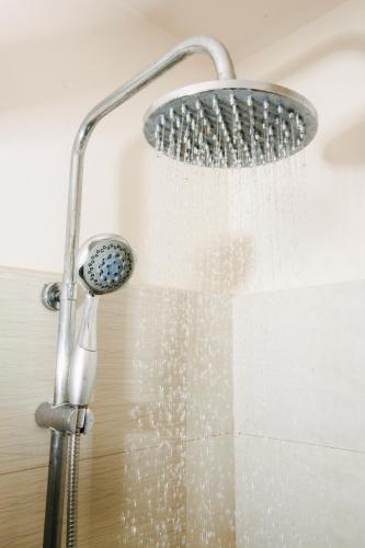 a shower head with water coming out of it at Go Hotels Ortigas Center in Manila