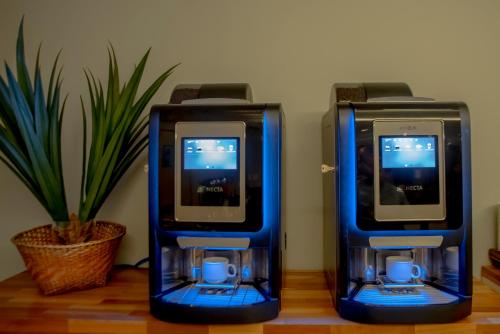 two blue video game machines sitting on a table at Hotel Saint George in Puerto Iguazú