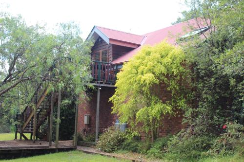 a brick house with a deck on the side of it at Storey Grange in Springwood