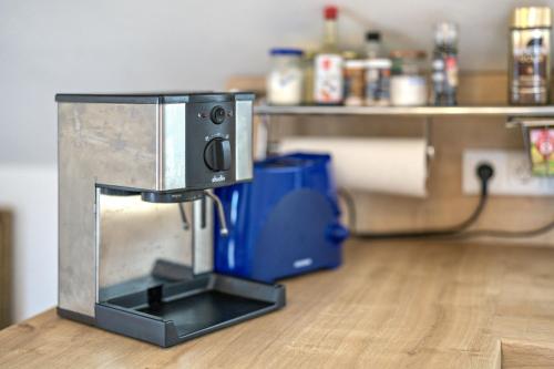 a coffee maker sitting on top of a wooden floor at Haus Rebberg in Wolfach