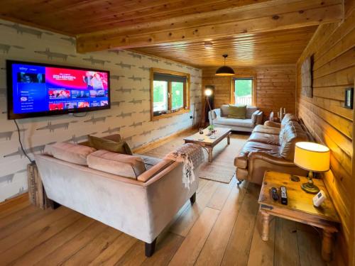 a living room with couches and a flat screen tv at Freedom Lodge Great Ayton Yorkshire in Great Ayton