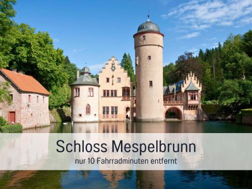 a castle in the middle of the water with the words schoolmiss megaevrem at Hotel Lamm in Heimbuchenthal