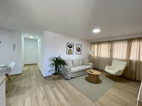 a living room with a couch and a table at Deluxe Home Las Palmas - by Gestión Vacacional Canarias in Las Palmas de Gran Canaria
