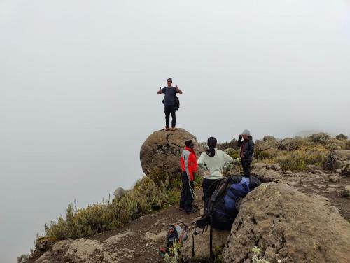 a group of people standing on top of a rock at Jabulani Nairobi Backpackers Hostel in Nairobi