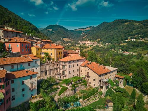 a town on a hill with mountains in the background at Cà Nani Small Boutique Hotel in Casima