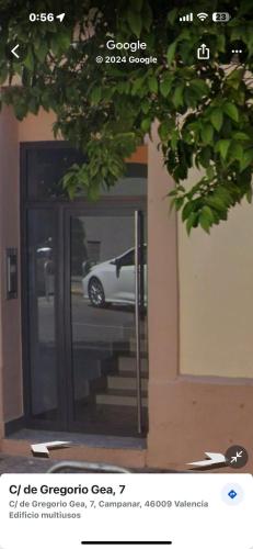 a white car is parked outside of a building at Habitacion privada in Valencia