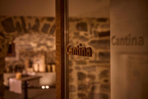 a glass door with the word canina written on it at Cà Nani Small Boutique Hotel in Casima