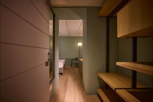 a small room with a bed and a door at Cà Nani Small Boutique Hotel in Casima
