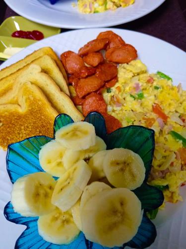 a plate of food with eggs and bananas and toast at Residencial Santa Catalina Pedasi in Pedasí Town