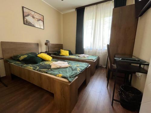 a room with two beds and a desk in it at apartament centrum RP in Katowice
