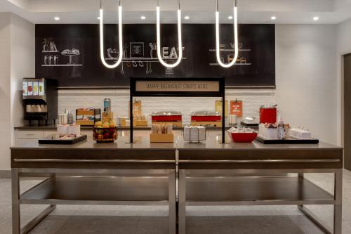 a restaurant with a counter with food on it at Hampton Inn By Hilton Winnipeg Downtown in Winnipeg