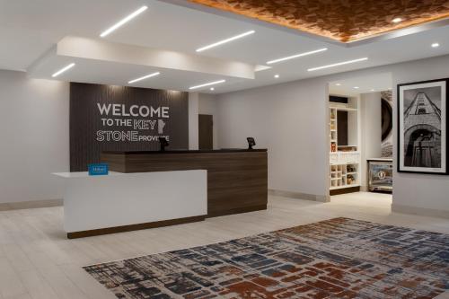 a lobby with a welcomeelcome to the next stinemann store at Hampton Inn By Hilton Winnipeg Downtown in Winnipeg