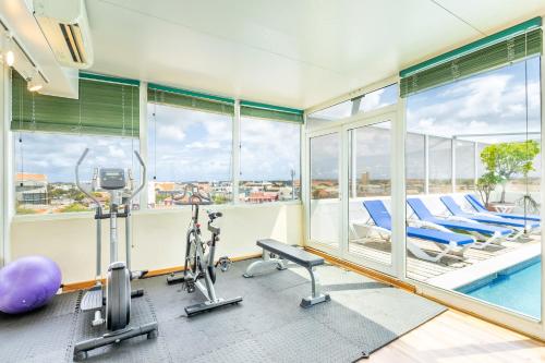 an apartment gym with a pool and exercise equipment at Bocobay Penthouse 4BR 4BA with Rooftop Pool in Oranjestad