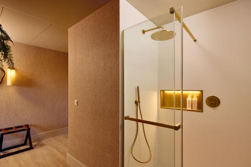 a shower with a glass door in a bathroom at Van Der Valk Luxembourg Arlon in Arlon