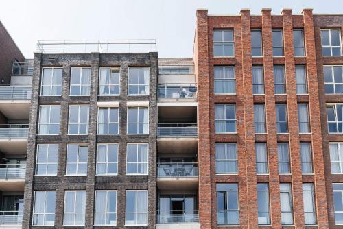 an external view of a brick building at Bizstay Harbour II Scheveningen Apartments in Scheveningen
