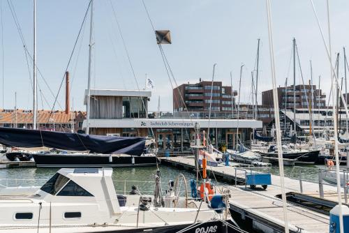 a boat docked at a marina with other boats at Bizstay Harbour II Scheveningen Apartments in Scheveningen
